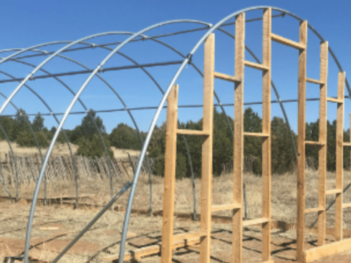 A recently built greenhouse ready for a plastic sheeting cover.