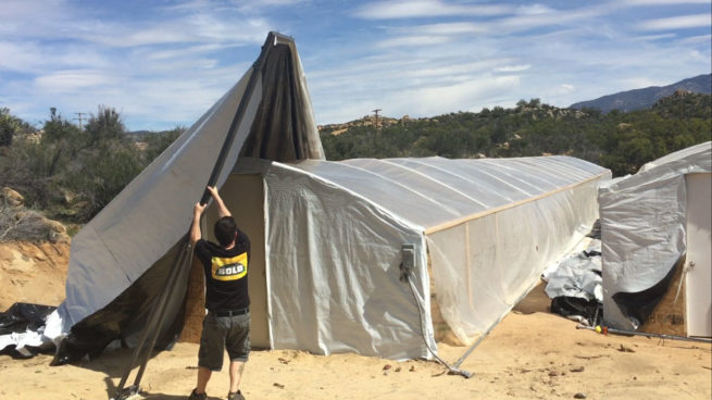 Bold light deprivation greenhouse with tarp puller